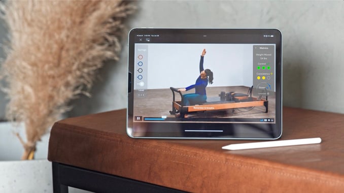 Copy of Tablet-Screen-with-pilates-class-playing Large (1)